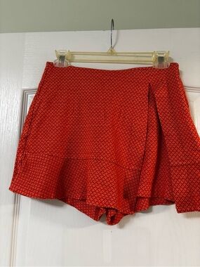 CAbi Matchmaker skort in orange red pattern.  Size 2.
